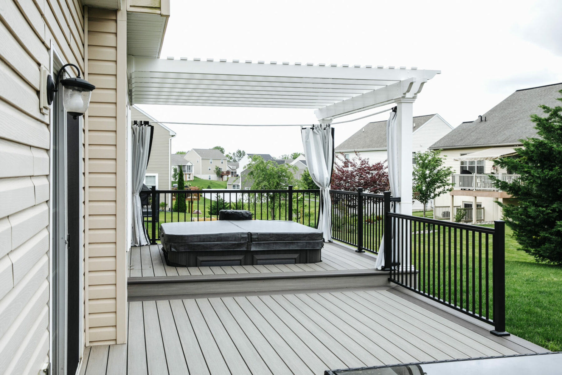 Azek deck with White Pergola Covering hot tub area