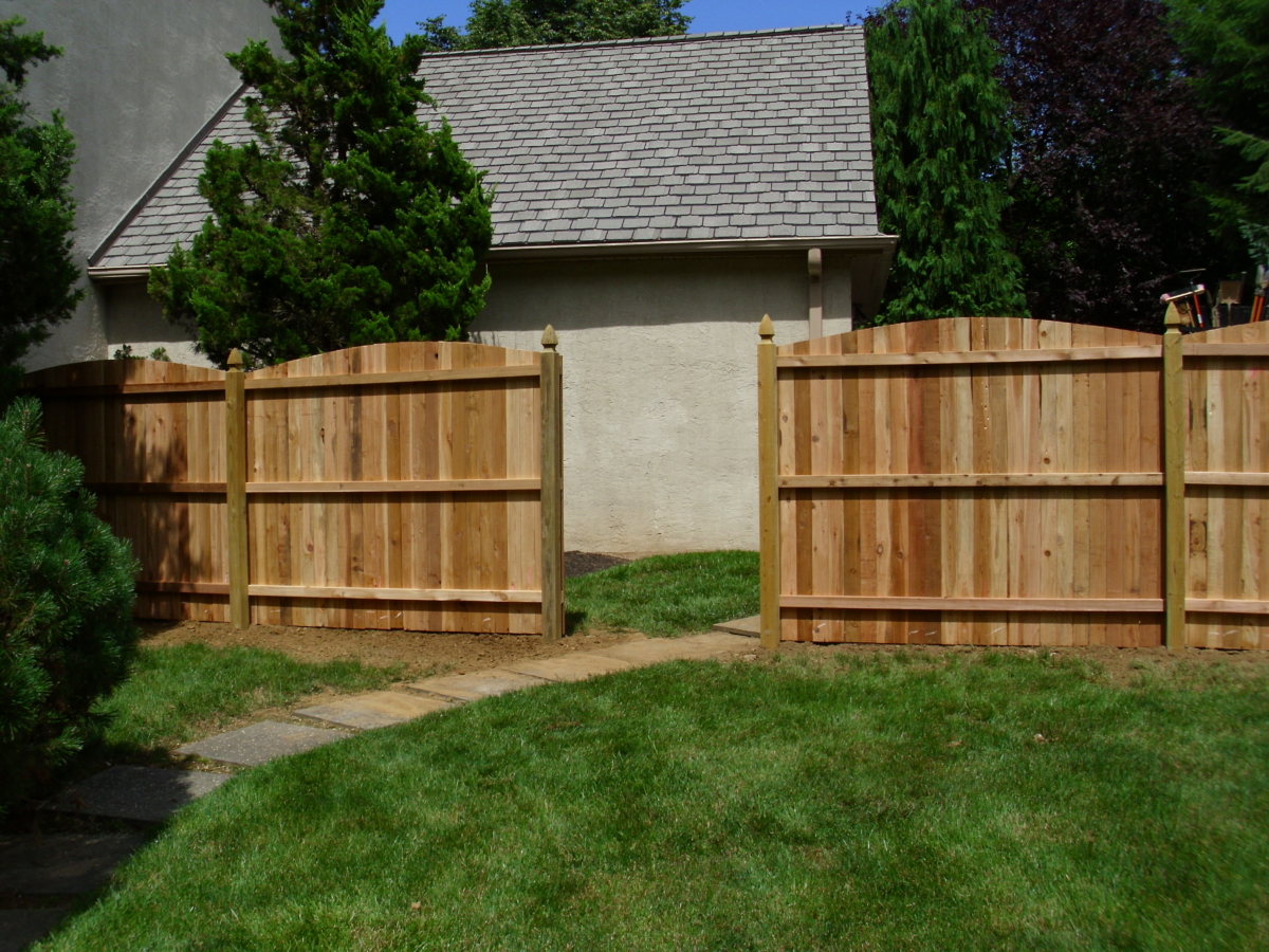 6' tall domed top solid board fence with French Gothic posts