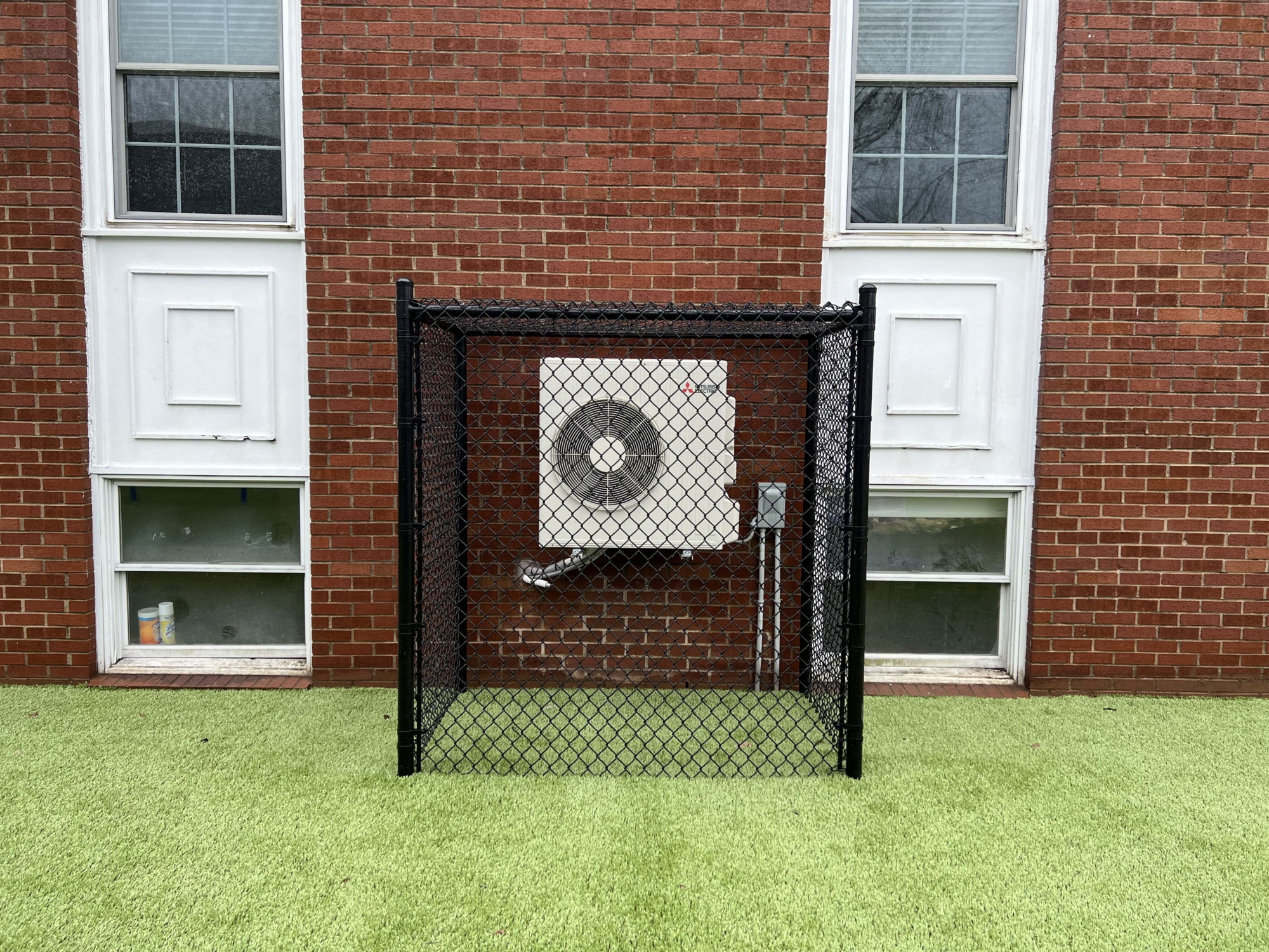 black chainlink fence surrounding utility