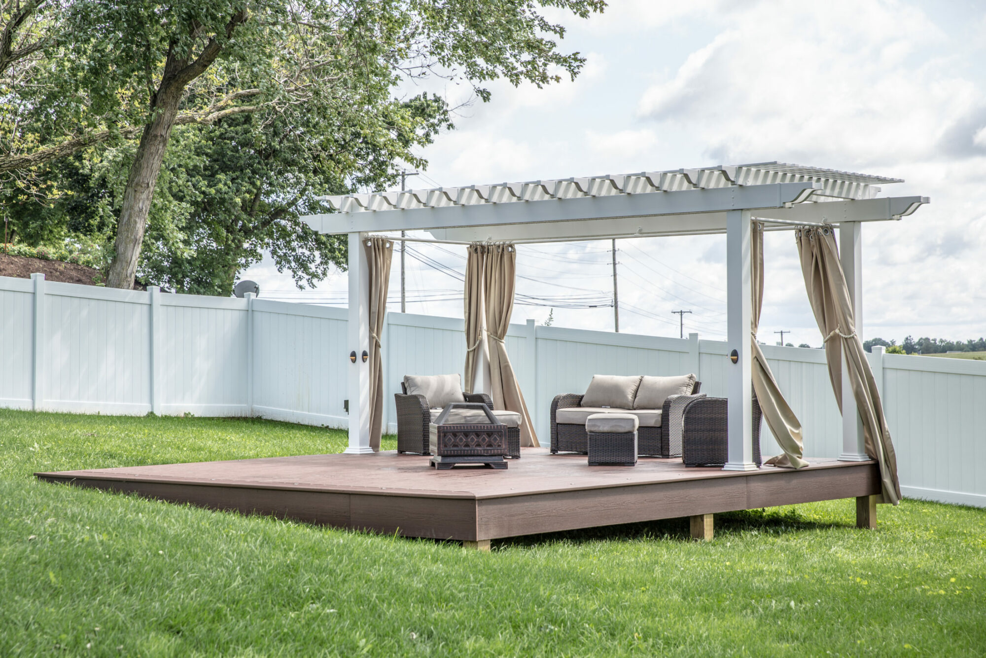 Detached deck with pergola in middle of backyard