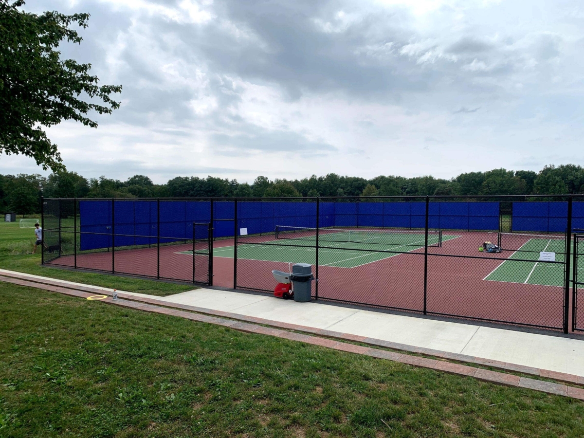 black chain link fence around tennis courts