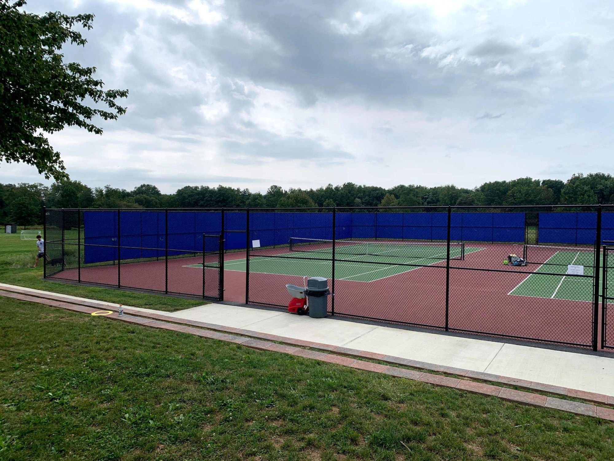 black chain link fence around tennis courts