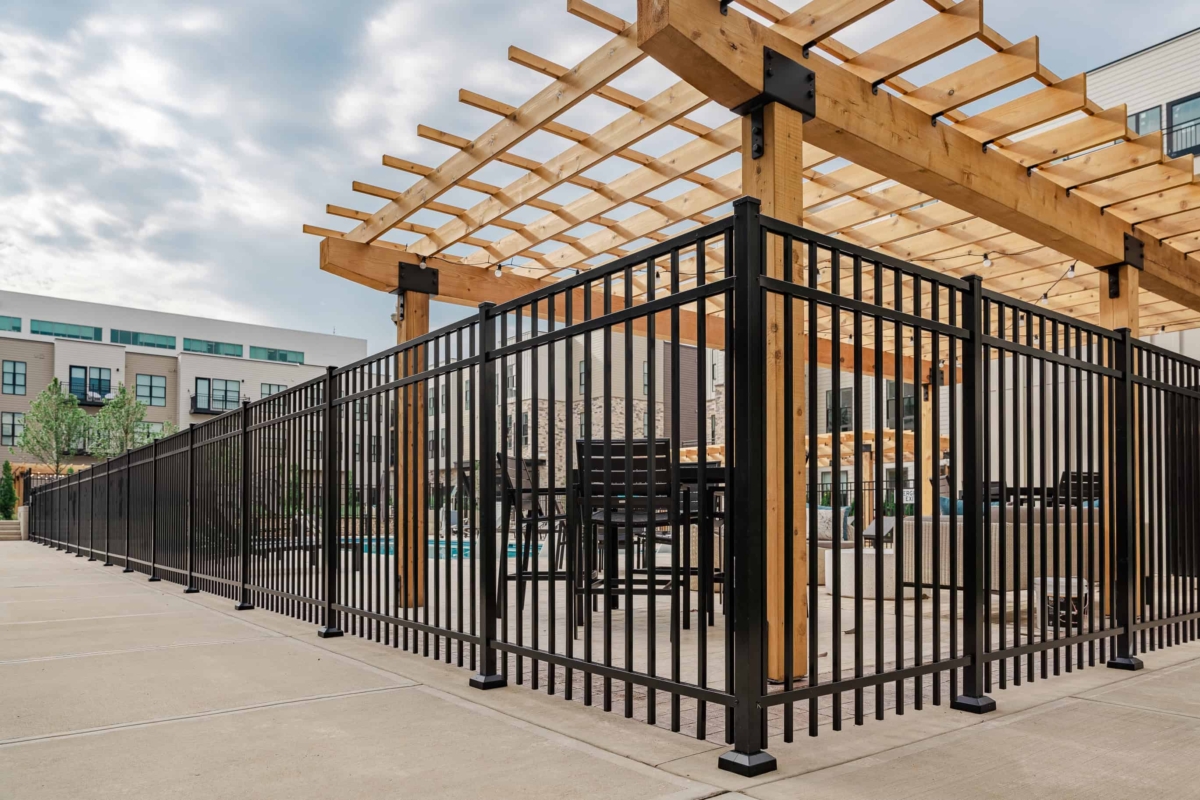 black metal fence around apartment pool