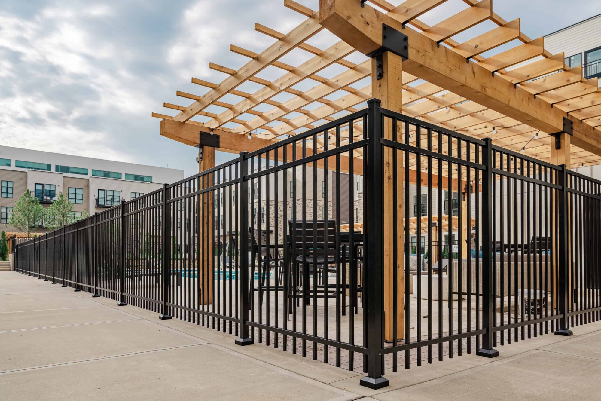 black metal fence around apartment pool