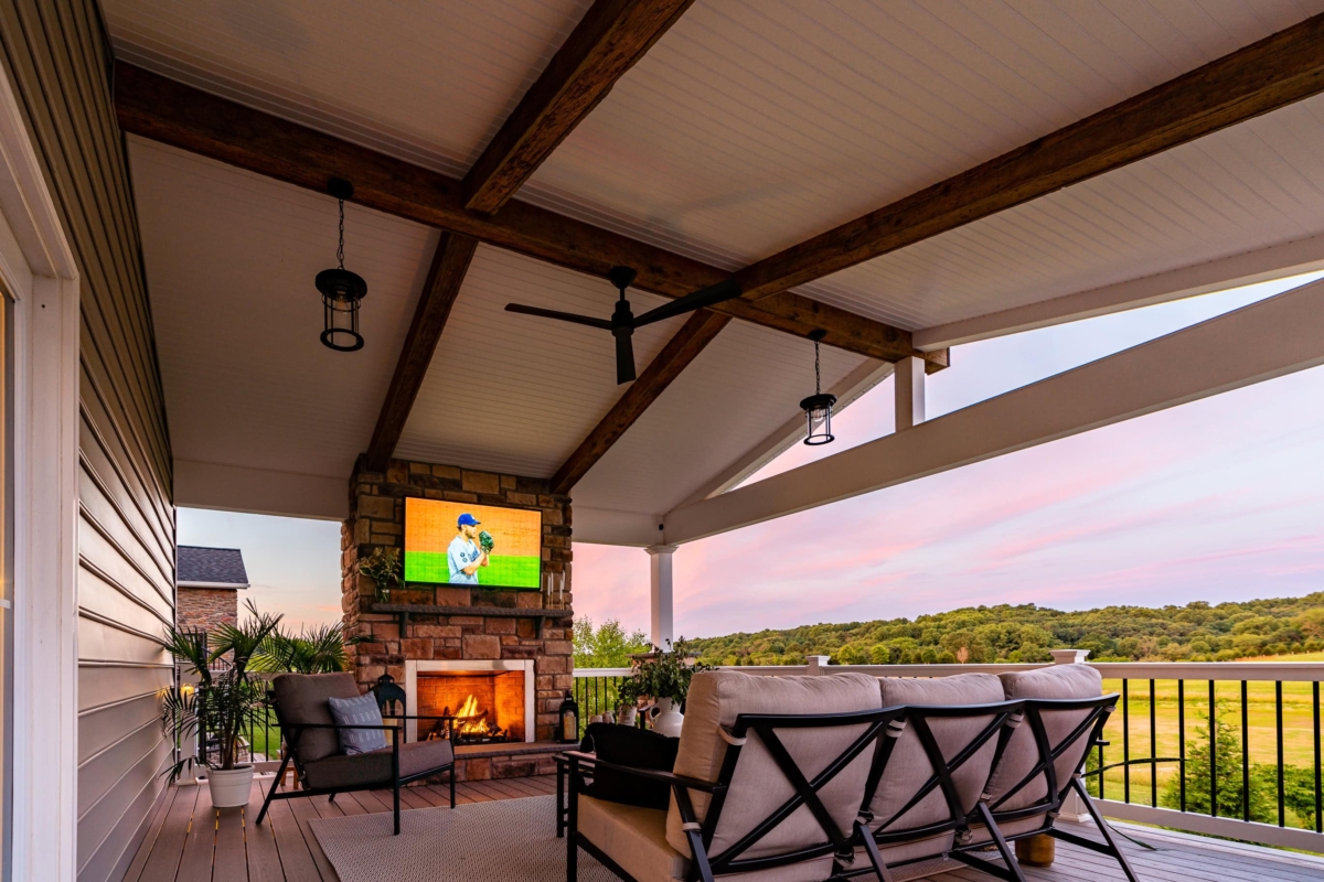 deck with roof and outdoor fireplace