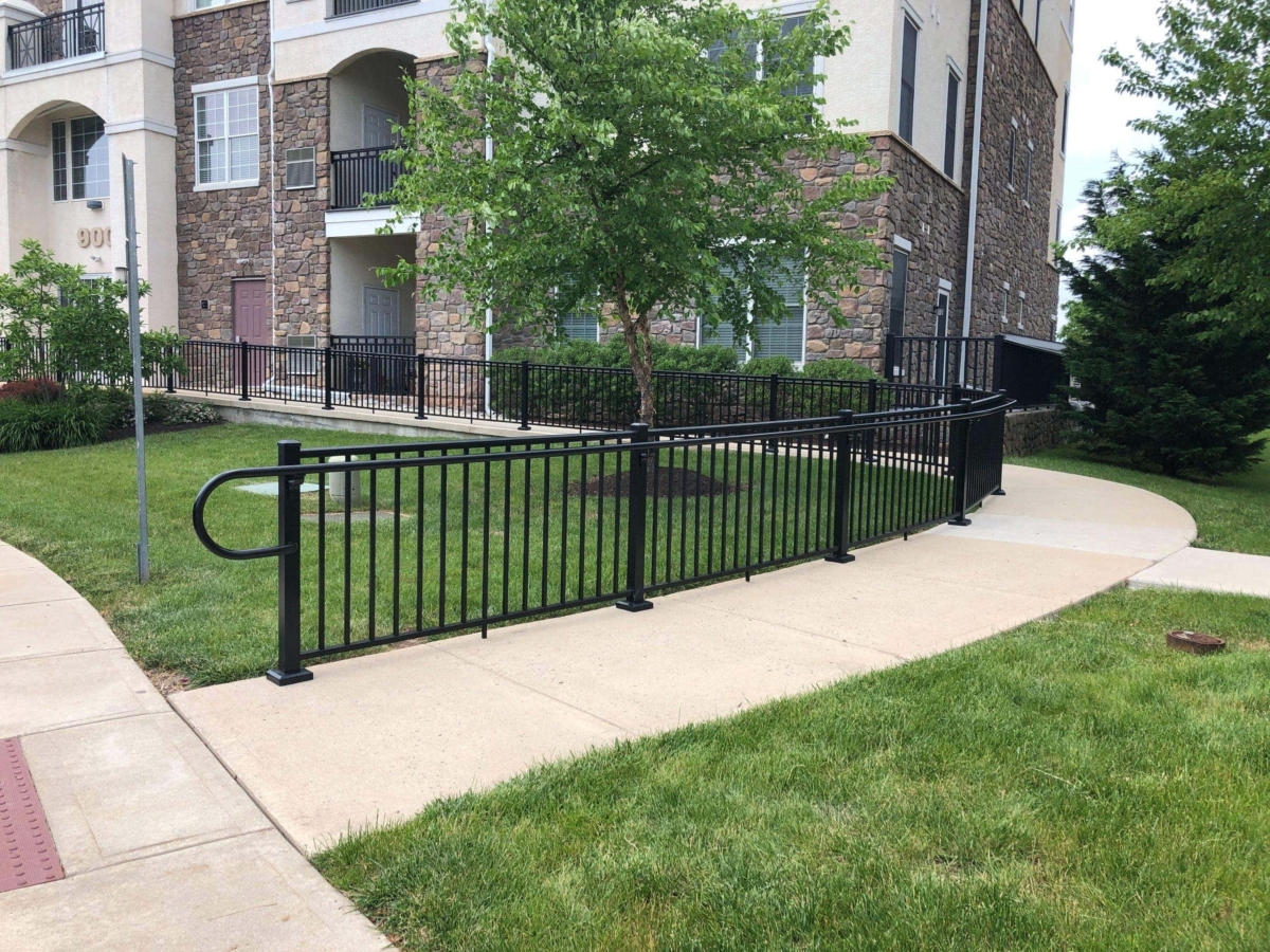 black curved metal railing with guiderail