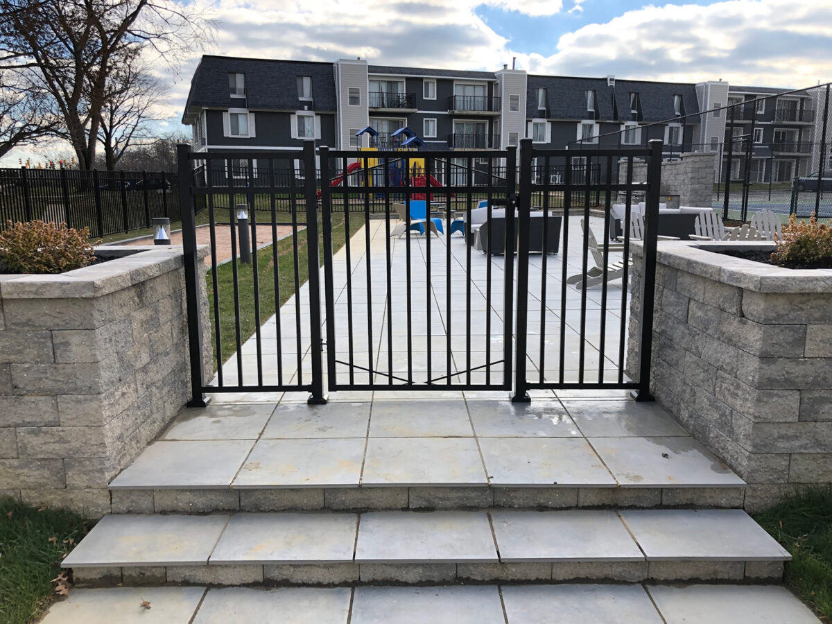 black ornamental fence around pool with gate