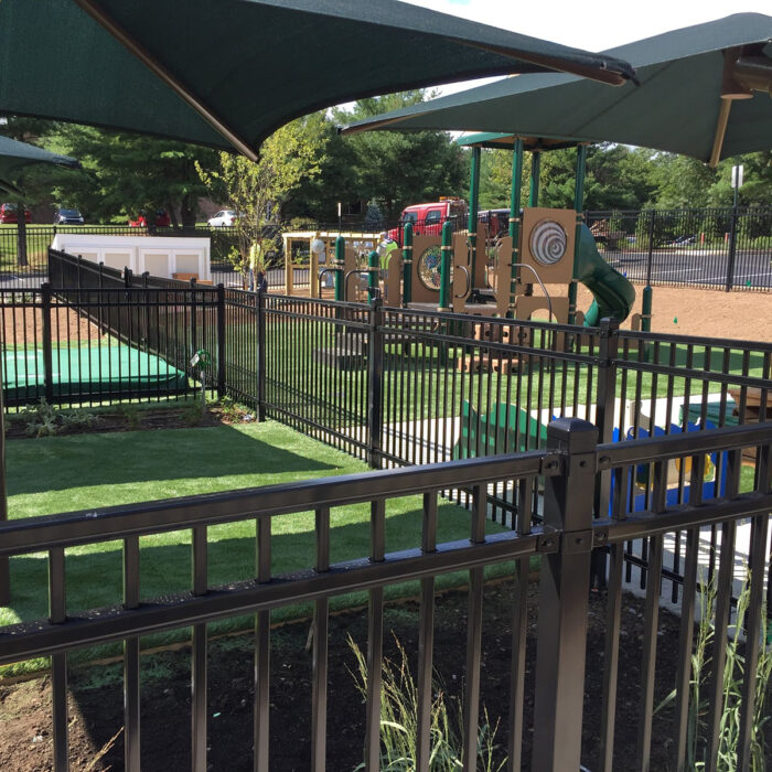 black commercial metal fence in playground