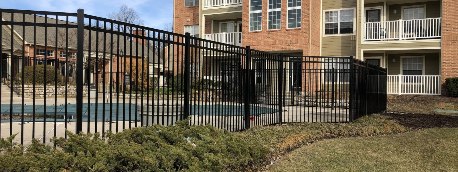 black commercial fence around pool