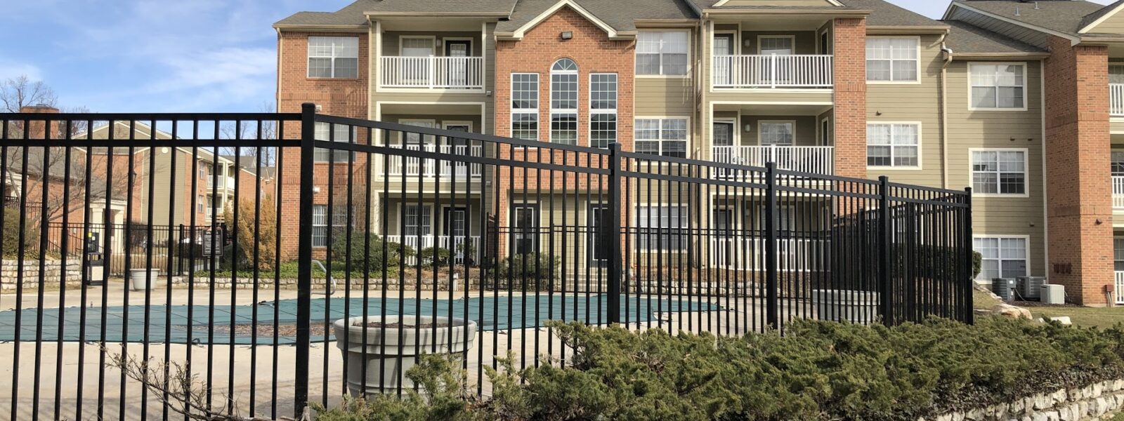 black commercial fence around pool