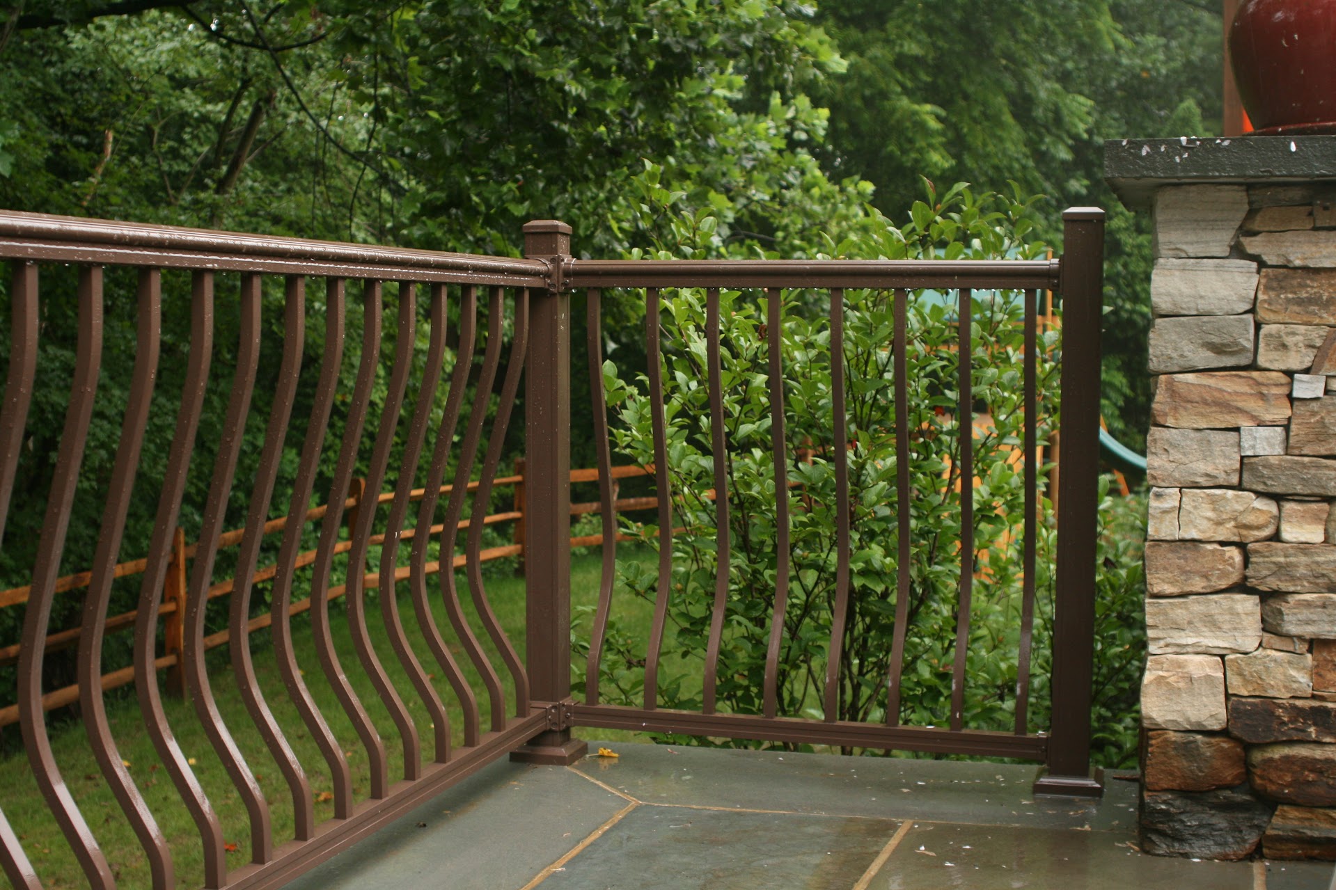 bronze railing on stone patio