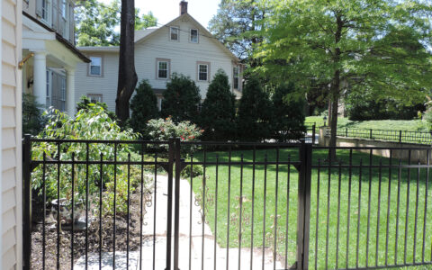 Ornamental aluminum fence with double gate in yard