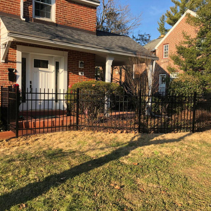 Ornamental aluminum fence with gate in yard