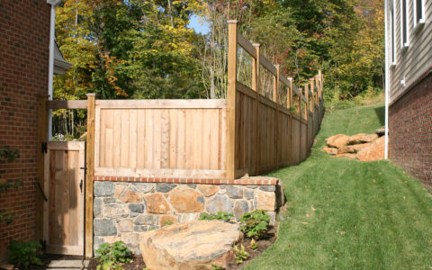 wooden fence with small gate on to pof wall