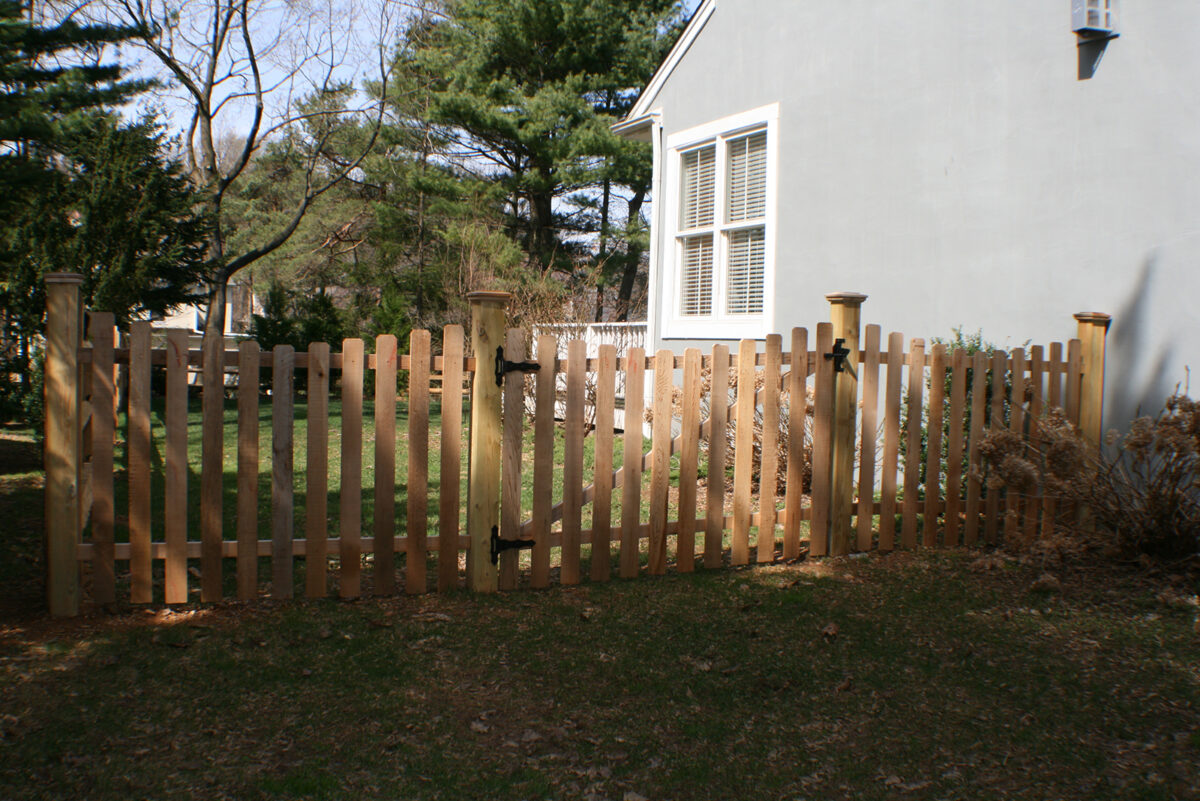 concaved wood picket fence with gate