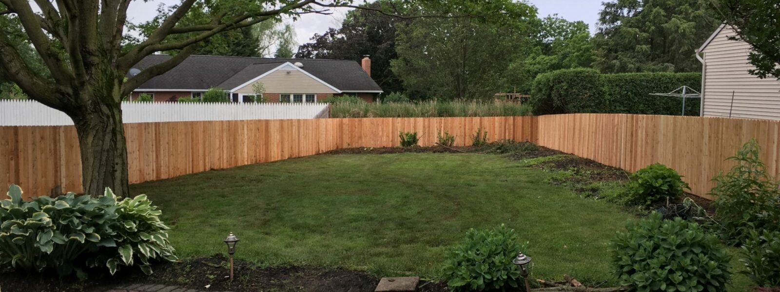 wood sounds abatement fence in yard