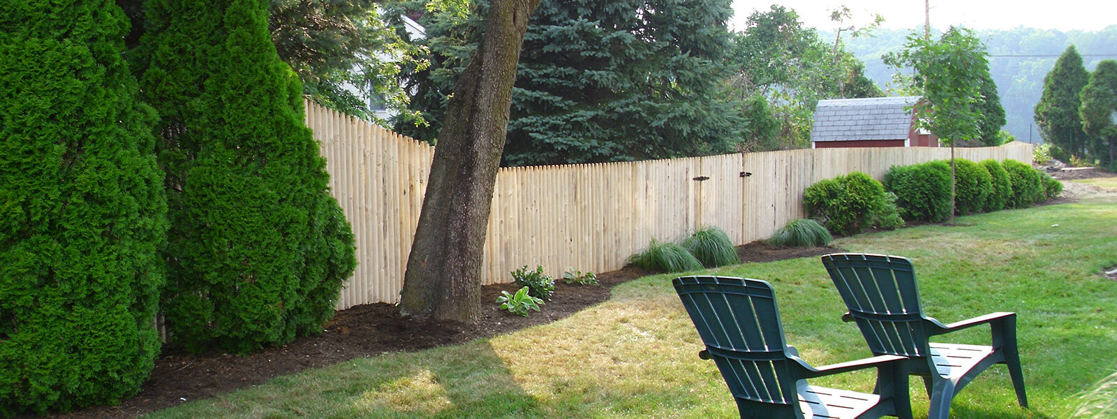 Stockade fence in yard with gate