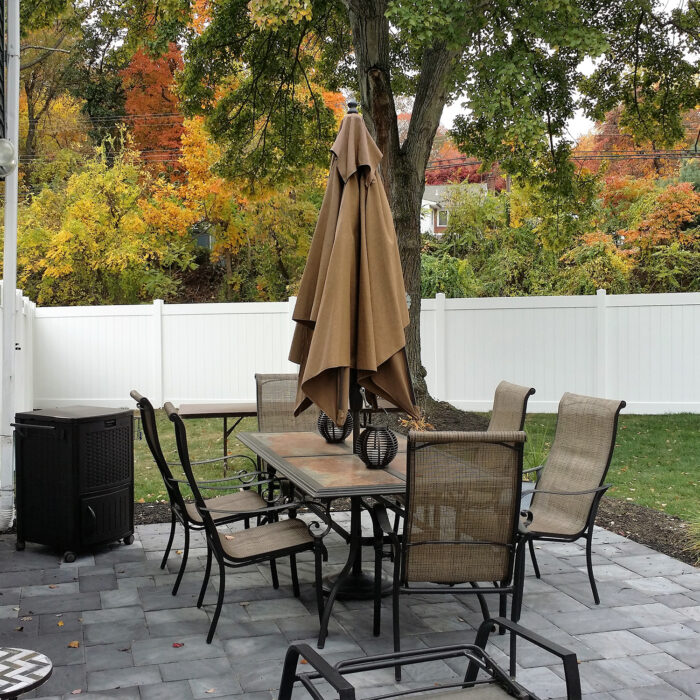 white privacy fence in yard with picnic table