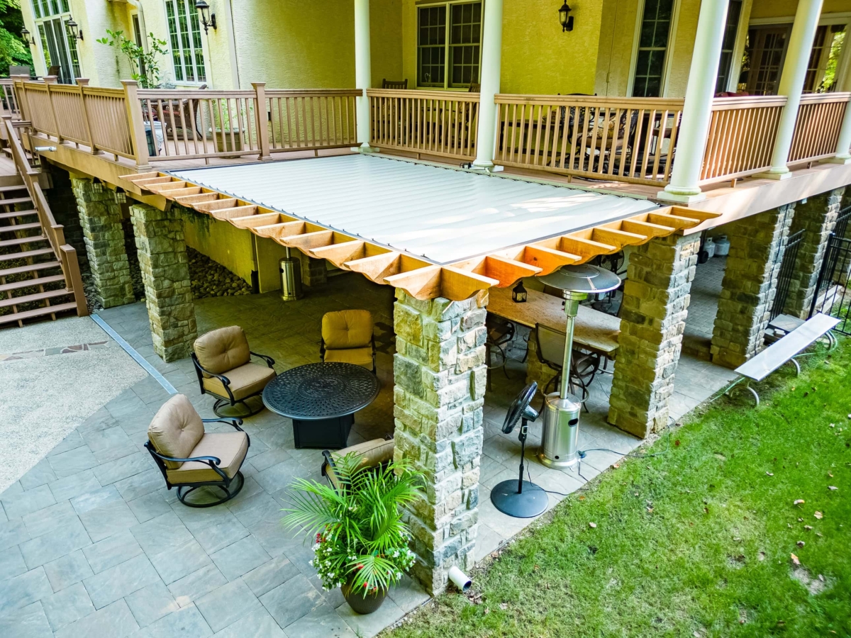 louvered pergola with stone pillars
