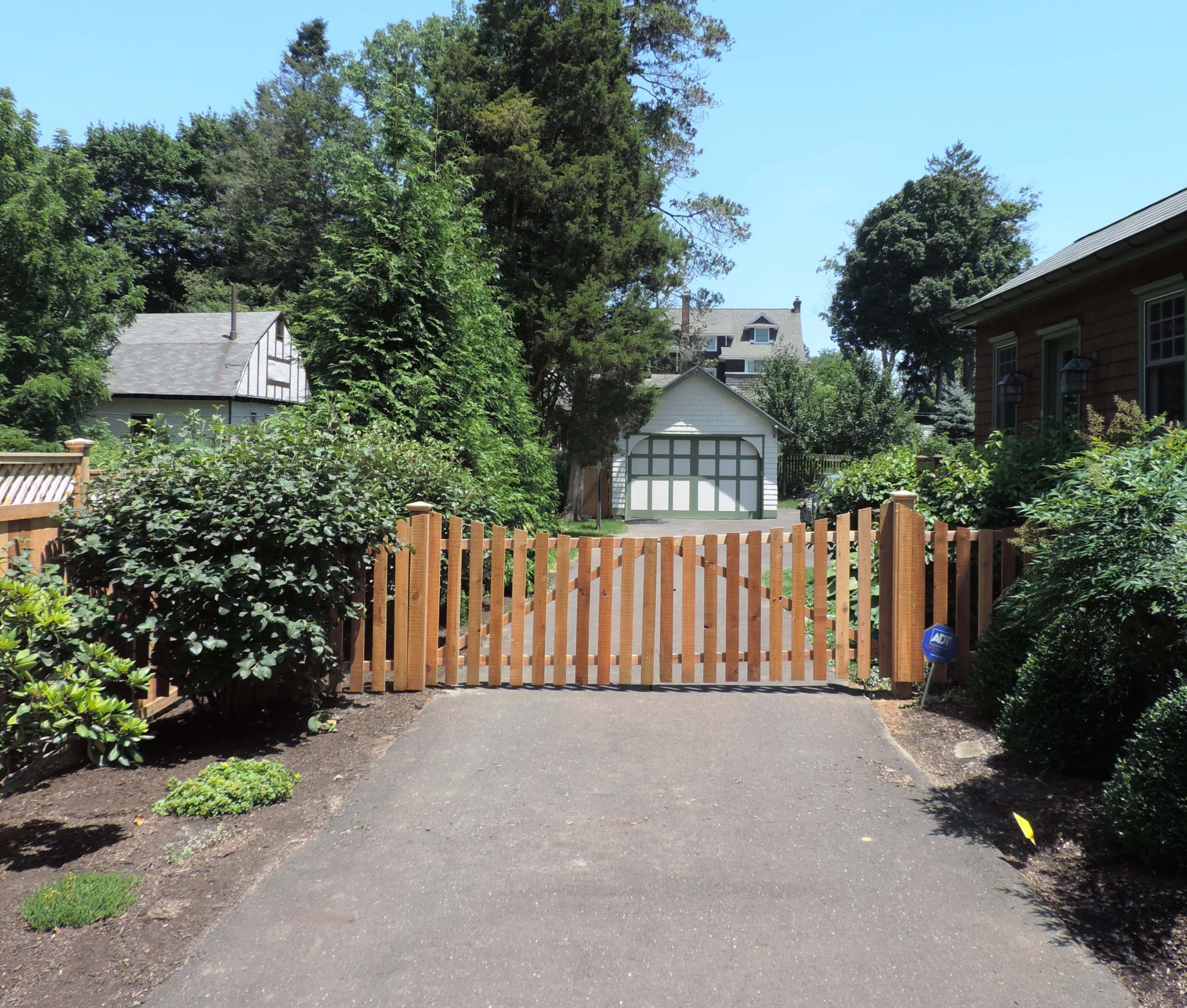wood picket residential driveway gate