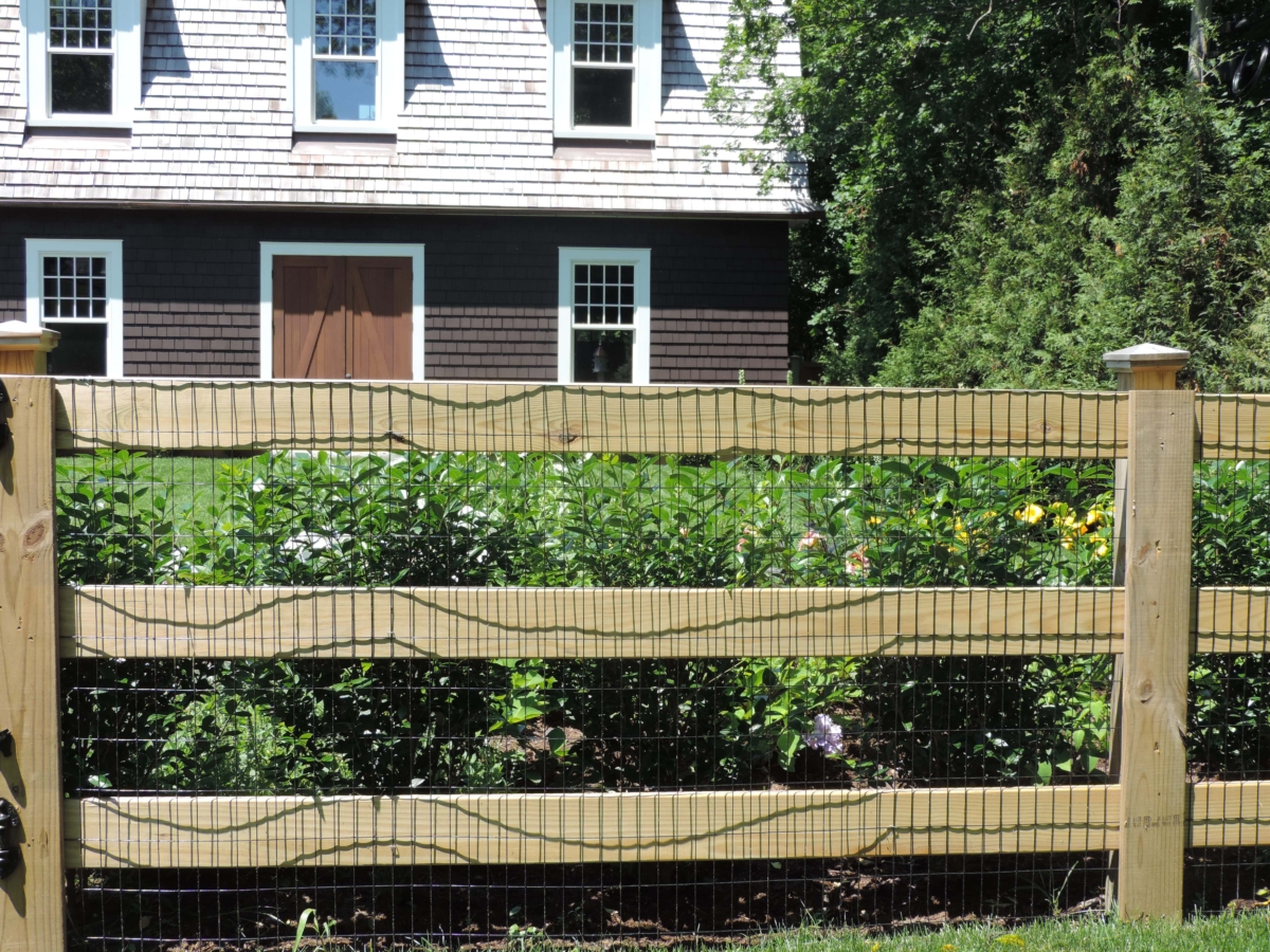 wood ranch rail with wire mesh fence