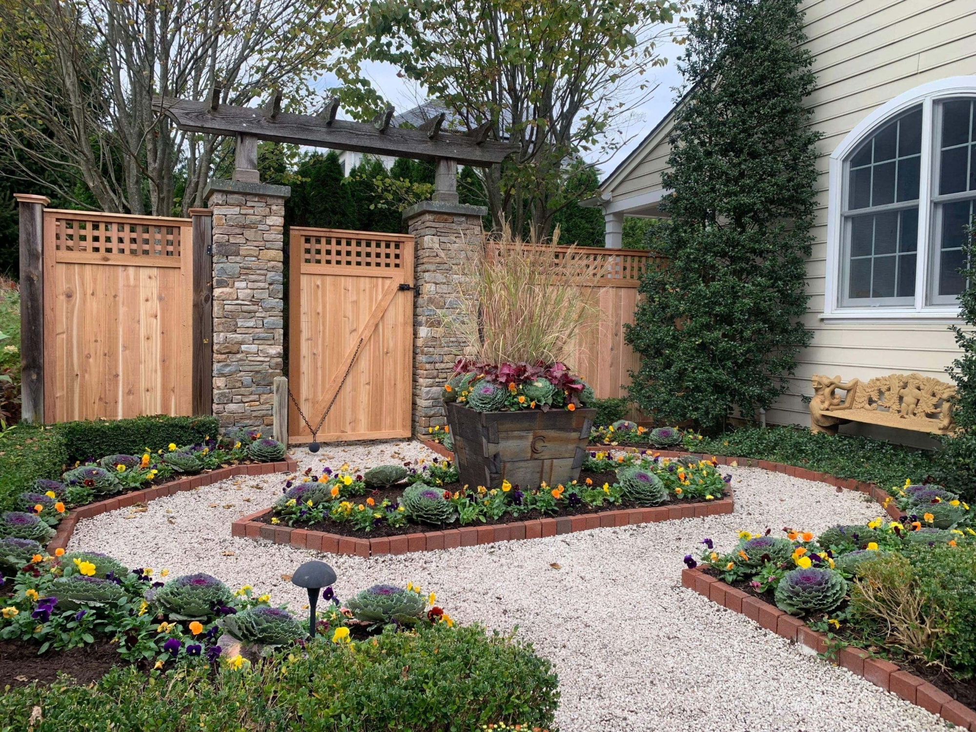 wood and stone arbor along fence