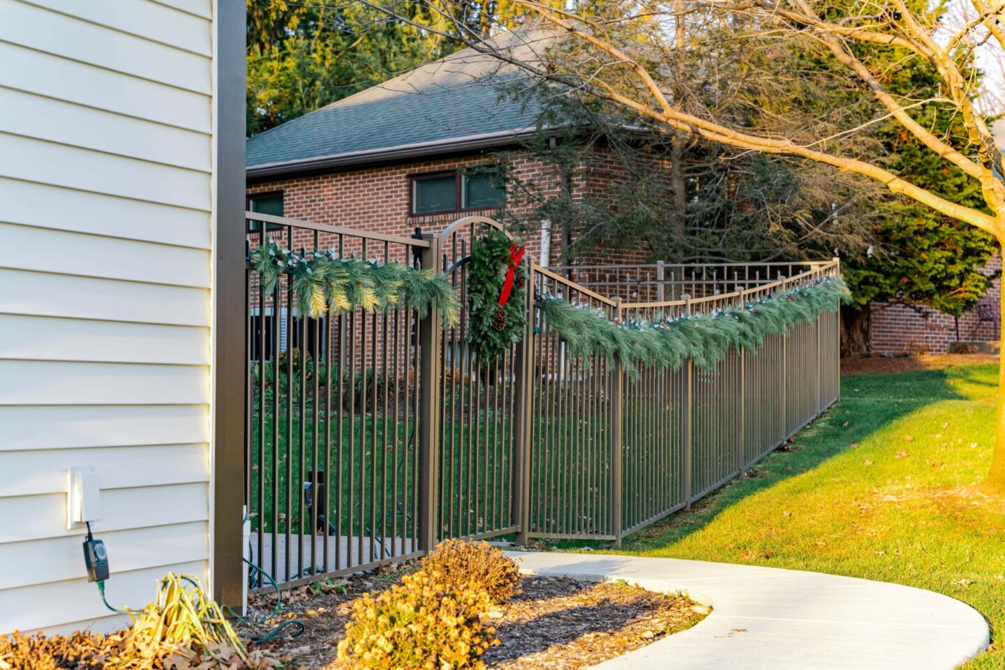 Black Metal Fence Decorated with Christmas Greens