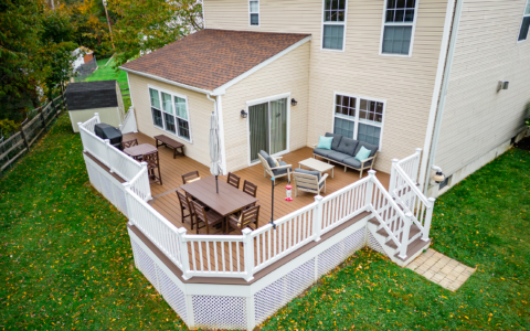 image of a deck with lattice skirting in media pa built by integrous fences and decks featuring timbertech decking white vinyl railing, and white vinyl underdeck lattice skirting with two steps to grade