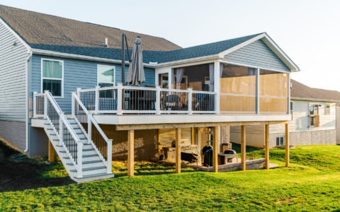 image of a deck with a screened in roof in coatesville pa built by integrous fences and decks featuring a screened in roof area an open deck timbertech decking white vinyl railing with black aluminum balusters and one set of stairs to grade
