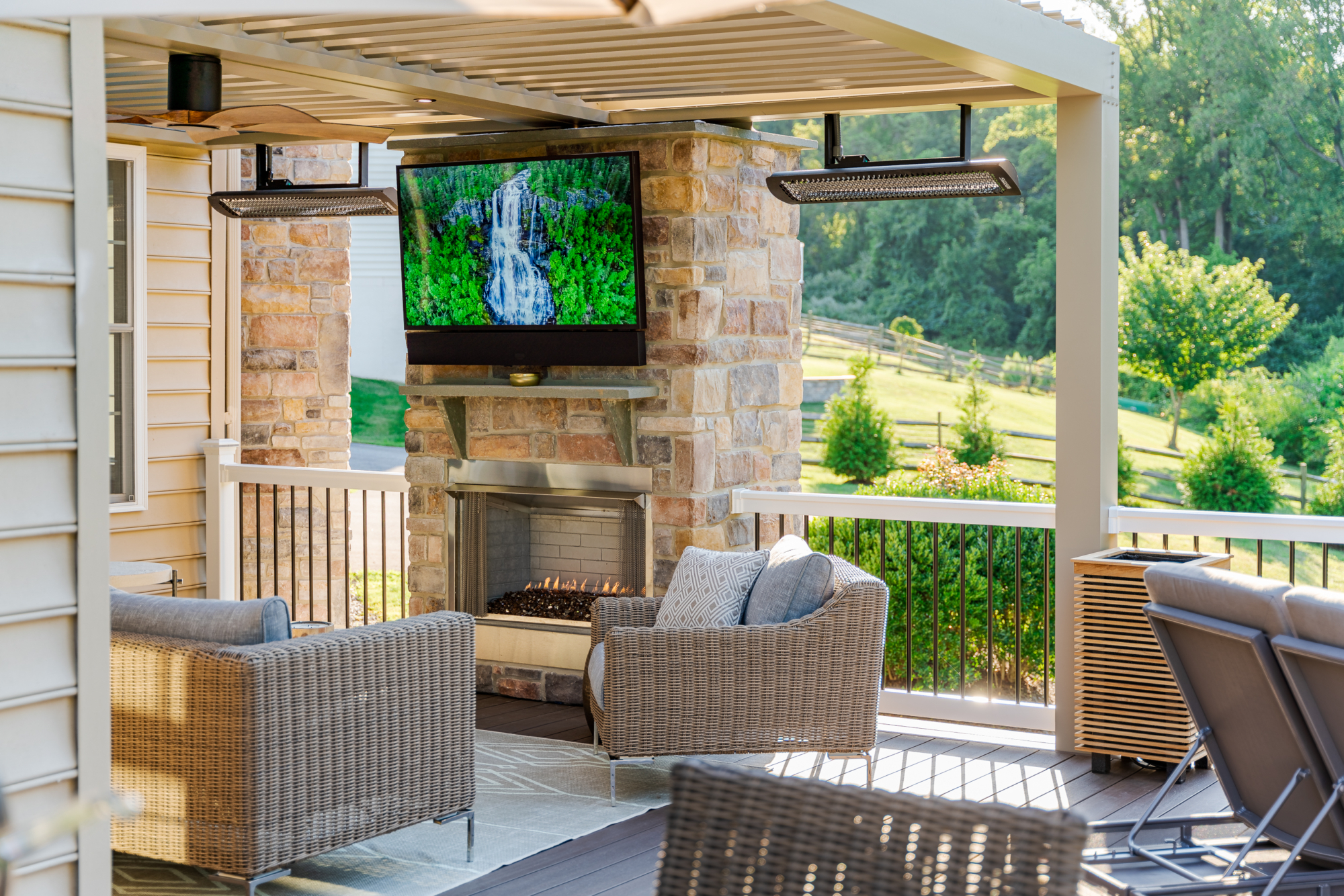 image of a louvered roof with outdoor heaters and a fireplace built by integrous fences and decks