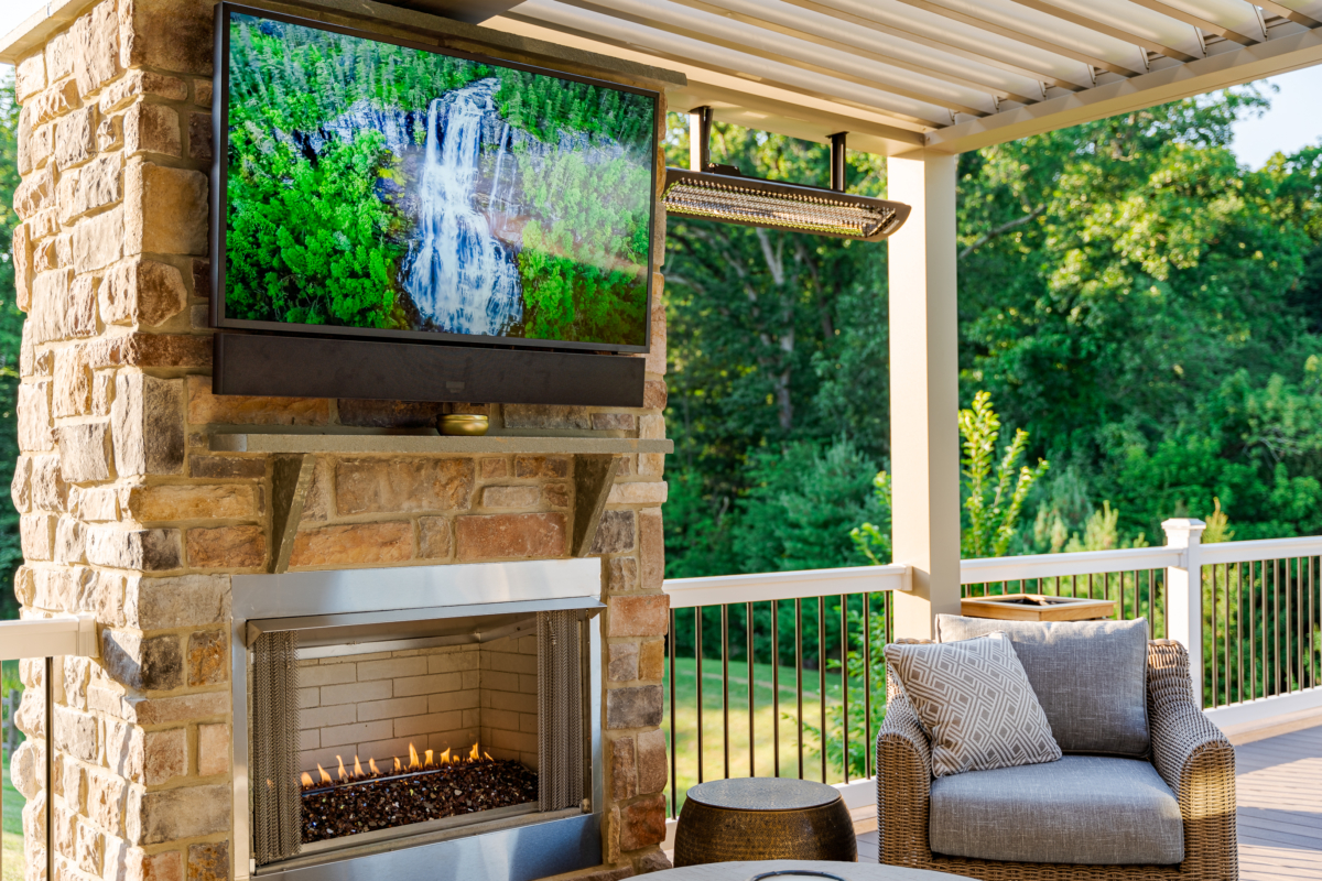 image of an outdoor fireplace and outdoor heaters creating a warm outdoor living space built by integrous fences and decks